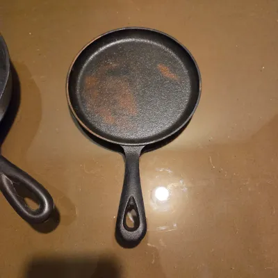 Sale Photo Thumbnail #427: Two cast iron skillets. #5 -  2 notch Lodge and a little skillet