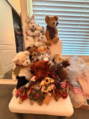 Sale Photo Thumbnail #10: Collection of Boyds Bears and Friends plush animals, including various teddy bears, a rabbit, and a moose, displayed on a chair.