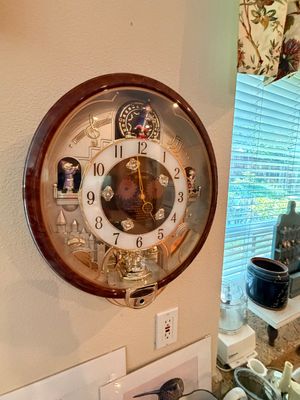 Sale Photo Thumbnail #11: Seiko Melodies in Motion wall clock featuring a wooden bezel, rotating pendulum, and animated musical figures.
