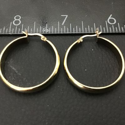 Sale Photo Thumbnail #69: Pair of gold-tone hoop earrings featuring latch-back closures. Marked '925' indicating sterling silver construction with a gold-plated or vermeil finish. Each earring measures approximately 1 inch in diameter. In good pre-owned condition with light surfac
