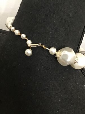 Sale Photo Thumbnail #215: Vintage single-strand choker style statement necklace featuring large baroque-style faux pearl beads alternating with gray and white swirled resin/plastic beads, accented with filigree end caps. Features a J-hook clasp stamped 'JAPAN' with an adjustable p