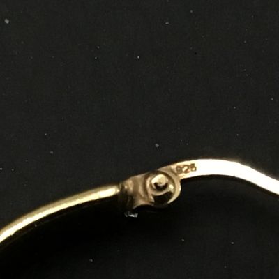 Sale Photo Thumbnail #70: Pair of gold-tone hoop earrings featuring latch-back closures. Marked '925' indicating sterling silver construction with a gold-plated or vermeil finish. Each earring measures approximately 1 inch in diameter. In good pre-owned condition with light surfac