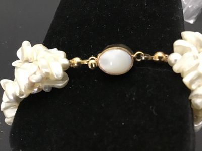 Sale Photo Thumbnail #125: Multi-strand freshwater pearl or mother-of-pearl chip/nugget necklace featuring a gold-toned clasp marked '14K TGF' (14K Gold Filled) with a cabochon accent insert. Clasp and strands appear intact and in good condition with minor vintage wear.
