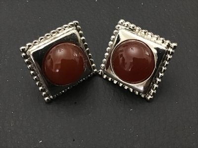 Sale Photo Thumbnail #167: Pair of square silver-tone pierce/post stud earrings featuring round, domed reddish-brown cabochons set in a square frame with beaded trim. Showing minimal wear, overall good condition.