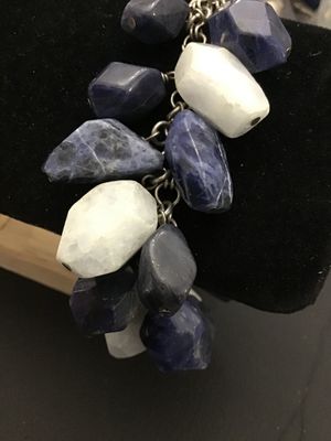 Sale Photo Thumbnail #144: A striking  925 chunky charm-style bracelet featuring large, faceted natural stone beads in shades of deep blue sodalite and white quartz or moonstone. The stones are attached to a silver-tone chain with a lobster claw clasp. The clasp appears to have fai