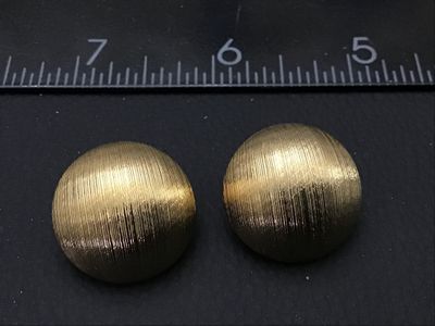 Sale Photo Thumbnail #156: Pair of vintage gold-tone clip-on earrings featuring a textured, ribbed half-dome design. Each earring measures approximately 1 inch in diameter. Clips are intact and functional. Excellent pre-owned condition with minimal signs of wear.