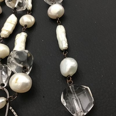Sale Photo Thumbnail #100: A long station-style strand necklace featuring an alternating arrangement of baroque freshwater pearls, stick pearls, and faceted clear crystal beads connected by dark wire wrapping. Interspersed with textured open-work metal oval links. Includes a lobste