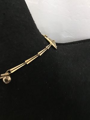 Sale Photo Thumbnail #118: A striking vintage multi-strand statement necklace featuring tiered rows of gold-tone bar-shaped links. Designed with a hook-and-tail clasp featuring a decorative sphere end cap. The necklace shows light wear consistent with age, with all strands intact a