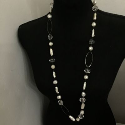 Sale Photo Thumbnail #101: A long station-style strand necklace featuring an alternating arrangement of baroque freshwater pearls, stick pearls, and faceted clear crystal beads connected by dark wire wrapping. Interspersed with textured open-work metal oval links. Includes a lobste
