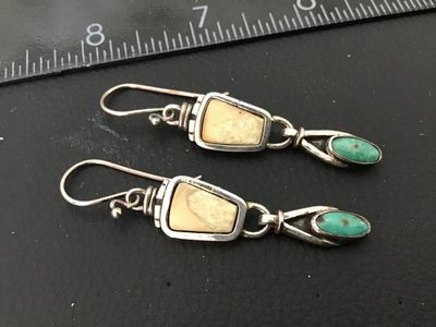 Sale Photo Thumbnail #14: Pair of handcrafted sterling silver Tone dangle drop earrings featuring bezel-set turquoise and light tan stone/jasper inlays. Features wire hooks with wire-wrap details. Overall good condition with light patina appropriate for age and wear.