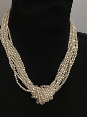 Sale Photo Thumbnail #202: Multi-strand faux pearl necklace featuring a knotted detail design in front and gold-tone spacer accent beads near the closure. Appears to be in good vintage condition with gentle surface wear. Perfect for elegant or formal occasions.