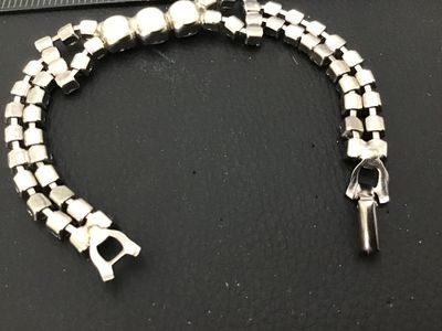Sale Photo Thumbnail #40: Vintage silver-tone costume jewelry bracelet featuring a double strand of prong-set clear sparkling rhinestones with a central focal accent of larger round rhinestones. Features a fold-over clasp closure. Measures approximately 7 inches in length. In good