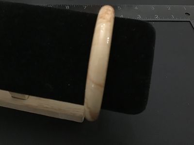 Sale Photo Thumbnail #229: A vintage solid bangle bracelet featuring a smooth, polished finish with cream and tan marbled or swirling tones, characteristic of faux tortoiseshell, celluloid, or resin/bakelite style jewelry. Measures approximately 2.5 inches in inner diameter based o