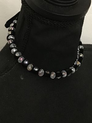 Sale Photo Thumbnail #206: Black velvet ribbon choker necklace featuring woven faceted glass or crystal beads with an aurora borealis iridescent finish. Ties in the back with adjustable fabric ribbons. Appears to be in good pre-owned condition with no loose or missing beads visible