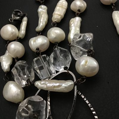 Sale Photo Thumbnail #99: A long station-style strand necklace featuring an alternating arrangement of baroque freshwater pearls, stick pearls, and faceted clear crystal beads connected by dark wire wrapping. Interspersed with textured open-work metal oval links. Includes a lobste