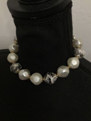 Sale Photo Thumbnail #214: Vintage single-strand choker style statement necklace featuring large baroque-style faux pearl beads alternating with gray and white swirled resin/plastic beads, accented with filigree end caps. Features a J-hook clasp stamped 'JAPAN' with an adjustable p