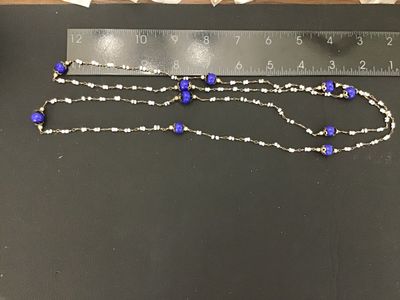 Sale Photo Thumbnail #24: Long vintage wire-wrapped beaded strand necklace featuring cobalt blue glass accent beads with filigree caps and white seed beads linked together with metal wire. Measures over 24 inches total length when doubled/extended as shown against the ruler. Showi