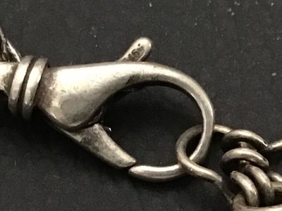 Sale Photo Thumbnail #146: A striking  925 chunky charm-style bracelet featuring large, faceted natural stone beads in shades of deep blue sodalite and white quartz or moonstone. The stones are attached to a silver-tone chain with a lobster claw clasp. The clasp appears to have fai