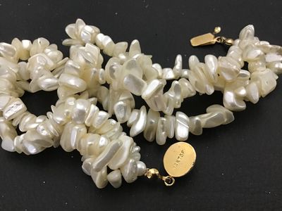 Sale Photo Thumbnail #123: Multi-strand freshwater pearl or mother-of-pearl chip/nugget necklace featuring a gold-toned clasp marked '14K TGF' (14K Gold Filled) with a cabochon accent insert. Clasp and strands appear intact and in good condition with minor vintage wear.