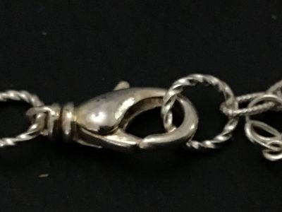 Sale Photo Thumbnail #54: A sterling silver charm bracelet featuring various celestial and aquatic/nautical themed charms including suns, butterflies, seashells, starfish, and sand dollars. Multiple charms are marked '925' for sterling silver quality. Features a lobster claw clasp