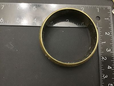 Sale Photo Thumbnail #222: A vintage gold-tone brass bangle bracelet featuring an intricate embossed floral and leaf design with textured background details. Inner diameter measures approximately 2.5 inches across. Shows minor age-appropriate wear and light patina.