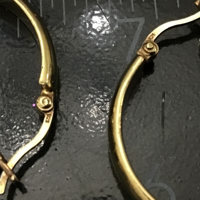 Sale Photo Thumbnail #71: Pair of gold-tone hoop earrings featuring latch-back closures. Marked '925' indicating sterling silver construction with a gold-plated or vermeil finish. Each earring measures approximately 1 inch in diameter. In good pre-owned condition with light surfac