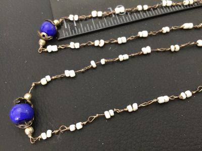 Sale Photo Thumbnail #21: Long vintage wire-wrapped beaded strand necklace featuring cobalt blue glass accent beads with filigree caps and white seed beads linked together with metal wire. Measures over 24 inches total length when doubled/extended as shown against the ruler. Showi