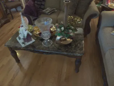 Sale Photo Thumbnail #13: Traditional marble-top coffee table with carved dark wood legs, displaying decorative glassware and holiday tabletop decor.