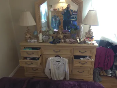 Sale Photo Thumbnail #18: Light oak triple dresser with an attached arched mirror, flanked by a pair of ornate brass table lamps.