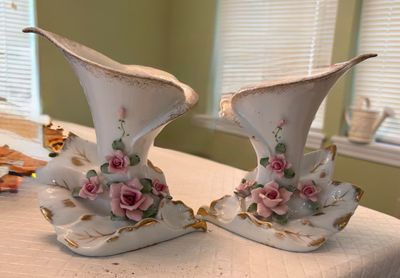 Pair of vintage porcelain calla lily-shaped vases with applied pink roses and gilded accents.