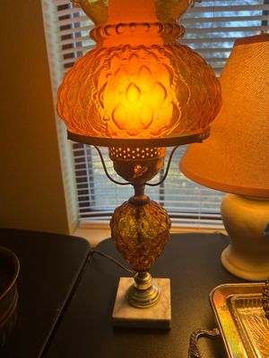 Vintage amber pressed glass table lamp featuring a textured globe shade, ornate urn-style body, and a square marble base.