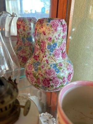 Vintage chintz porcelain bedside carafe set with pink roses and blue flowers, including a matching tumbler cup.