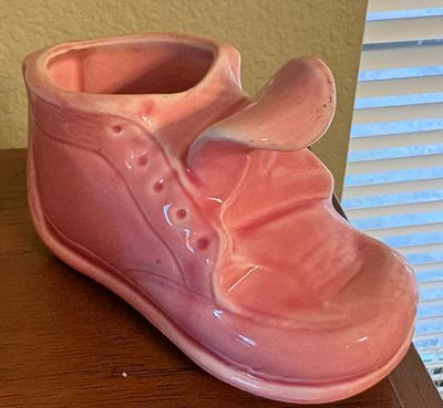 Vintage pink glazed ceramic baby shoe planter, mid-century style.