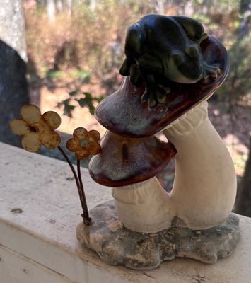 Vintage glazed ceramic figurine featuring a frog perched atop double mushrooms, accented with two small metal flower stems on the base.