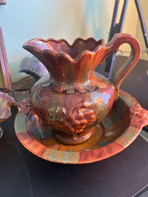 Vintage ceramic pitcher and wash basin set with a glossy drip glaze finish and embossed grape motif.