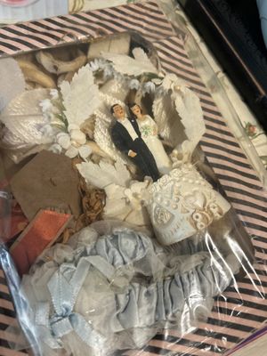 Vintage mid-century wedding keepsake shadowbox featuring a bride and groom cake topper, white fabric floral accents, and a light blue...