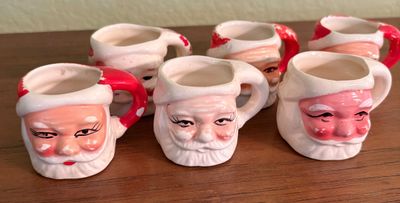Set of six vintage ceramic Santa Claus mini mugs or shot glasses with hand-painted details.