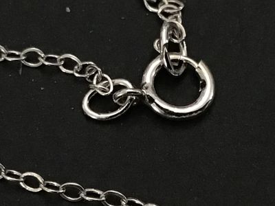 Sale Photo Thumbnail #144: A sterling silver heart-shaped pendant necklace featuring a reversible design. One side is adorned with multi-color round faceted gemstones including amethyst, peridot, citrine, garnet, and blue topaz, while the reverse side features a halo of uniform lig