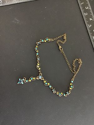 Sale Photo Thumbnail #25: Antiqued brass-tone Y-drop necklace set with blue, teal, and lime green rhinestones in delicate filigree scroll links. Features a lobster claw clasp with an adjustable extender chain. Good pre-owned condition with all stones intact.