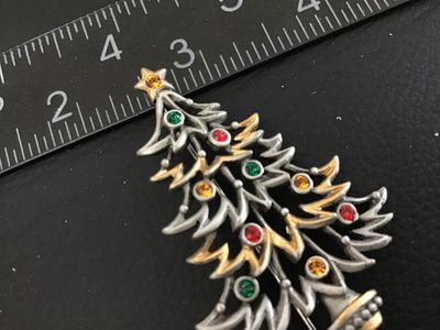 Sale Photo Thumbnail #52: Vintage Christmas tree brooch pin marked '©JJ' (Jonette Jewelry Co.) on the back. Features pewter-tone and gold-tone layered branches adorned with colorful red, green, and yellow rhinestone ornaments and a star topper. Measures approximately 2.25 inches 