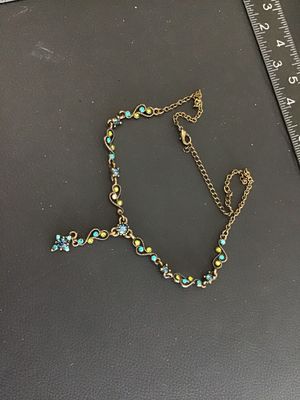 Sale Photo Thumbnail #26: Antiqued brass-tone Y-drop necklace set with blue, teal, and lime green rhinestones in delicate filigree scroll links. Features a lobster claw clasp with an adjustable extender chain. Good pre-owned condition with all stones intact.