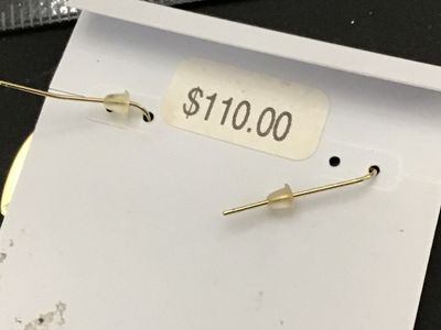 Sale Photo Thumbnail #135: Pair of Kendra Scott gold-tone drop earrings featuring red heart-shaped stones/inlays. On original brand display card with backings included. Original price tag showing $110.00 on back. New with tags condition with no visible damage or signs of wear.