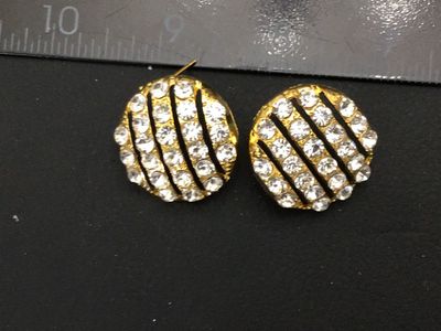 Sale Photo Thumbnail #206: Pair of round gold-tone pierced post earrings featuring rows of clear sparkling rhinestones separated by openwork stripes. Measure approximately 0.75 inches in diameter. Unmarked on reverse. Includes posts (earring backs not included). Good vintage condit