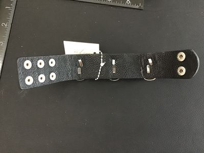 Sale Photo Thumbnail #58: Avenue Six Collection black textured leather or faux-leather cuff bracelet featuring three silver-tone metallic skulls set with clear rhinestone eyes and teeth accents. Secured with double snap closure. Measures approximately 8.5 to 9 inches long total. I