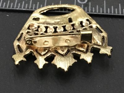 Sale Photo Thumbnail #87: Gold-tone metal brooch featuring a crown design with 'JESUS' spelled along the band. Set with multi-colored navette rhinestones in green, purple, red, topaz, and blue, topped with clear accent rhinestones. Measures approximately 1.5 inches wide. Standard 