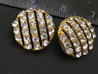 Sale Photo Thumbnail #205: Pair of round gold-tone pierced post earrings featuring rows of clear sparkling rhinestones separated by openwork stripes. Measure approximately 0.75 inches in diameter. Unmarked on reverse. Includes posts (earring backs not included). Good vintage condit