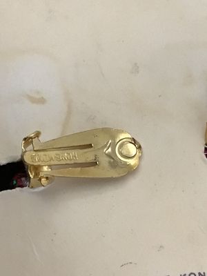 Sale Photo Thumbnail #40: Pair of vintage cluster clip-on earrings featuring vibrant magenta/fuchsia faux pearls, textured pink beads, and dark glittered accents. Set on gold-tone metal clip backs, marked 'HONG KONG'. Presented on original card backing marked 'Clip Earring' and 'M