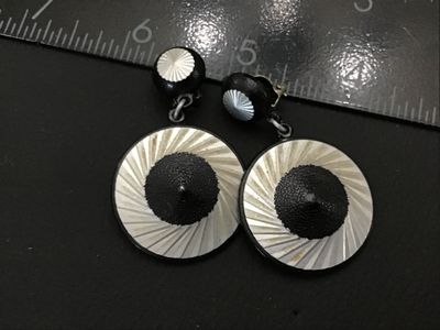 Sale Photo Thumbnail #175: Pair of vintage clip-on dangle earrings stamped 'W. GERMANY'. Feature a bold modern graphic design with concentric silver-tone radiating starburst patterns and textured black centers. Earrings measure approximately 2 inches in overall length. Clips show l