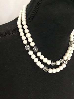 Sale Photo Thumbnail #63: Vintage mid-century double strand costume jewelry necklace featuring opaque white round beads interspersed with faceted clear glass accent beads. Includes an adjustable silver-tone tail chain clasp with bead drop. In good vintage condition with light, age