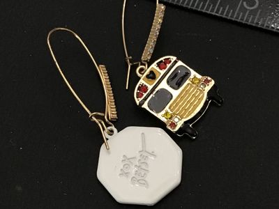 Sale Photo Thumbnail #130: Pair of Betsey Johnson mismatched drop/dangle wire earrings featuring a yellow enamel school bus with rhinestone accents on one side and a red glitter enamel stop sign on the other. Signed 'xox Betsey' on the back. Features gold-tone long French wire ear 